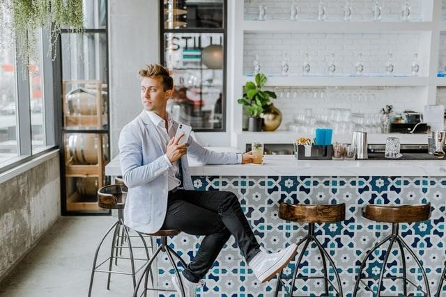 man posing at a cafe