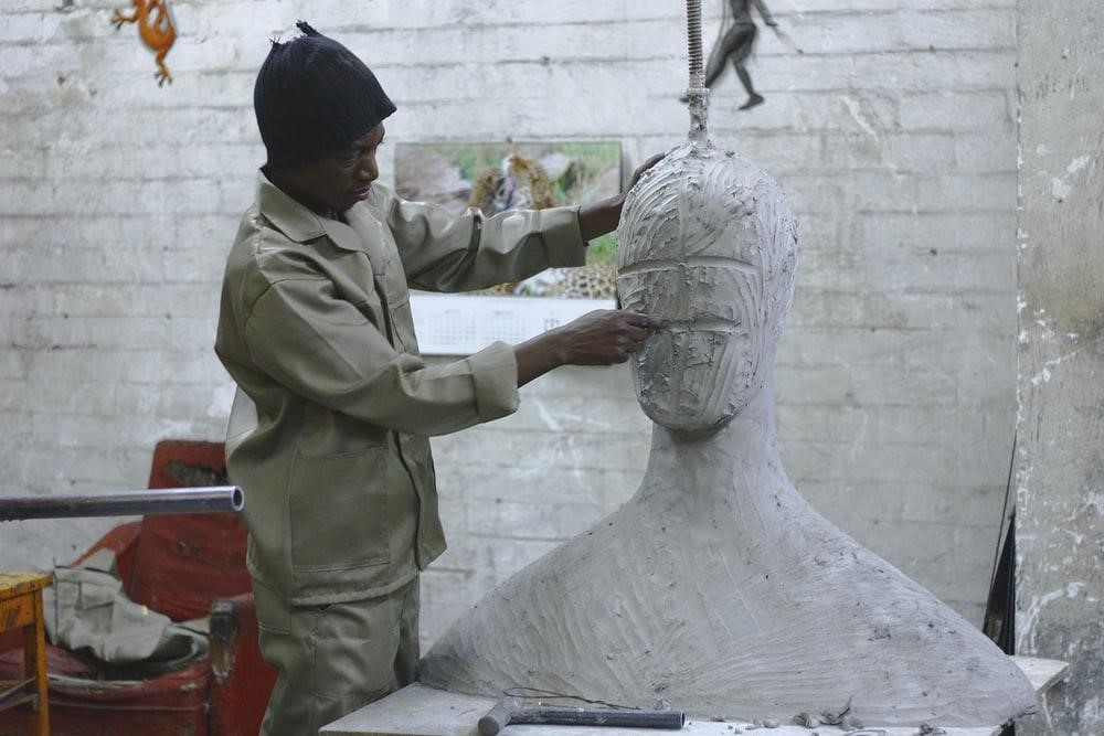 sculptor sculpting a statue