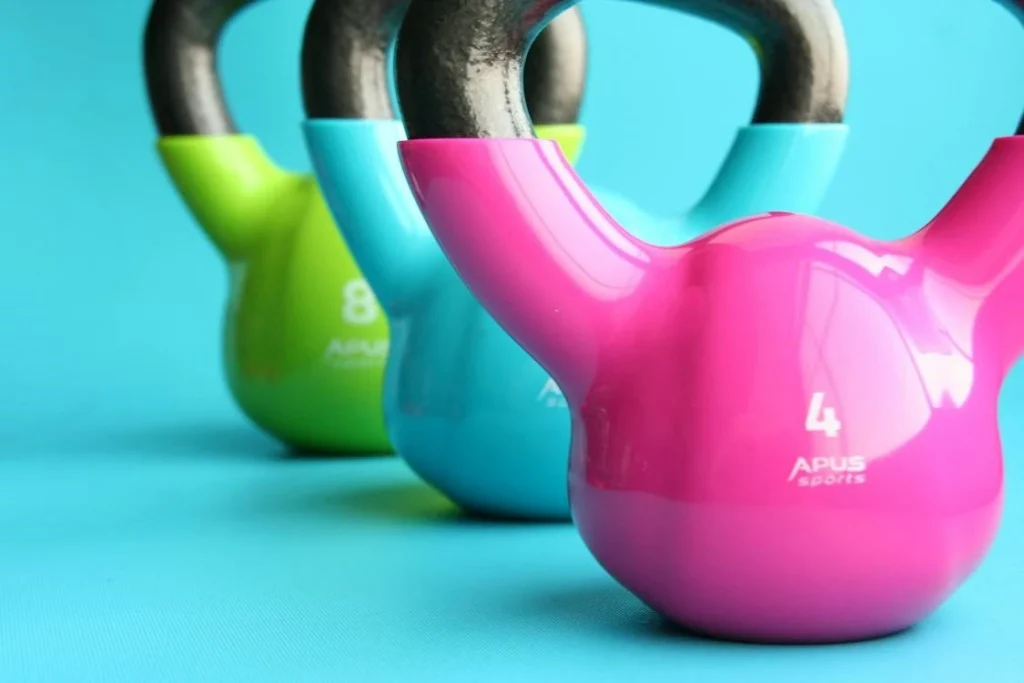 Colorful kettlebells with gym logo
